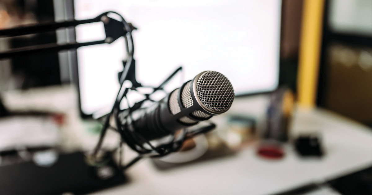 a podcast microphone connected to a desk