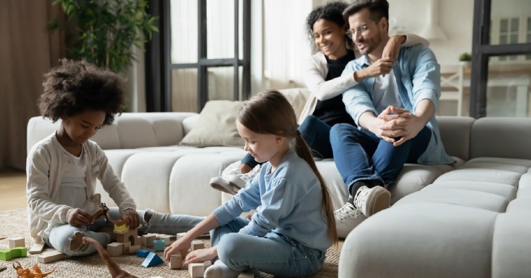 a family sitting on the couch