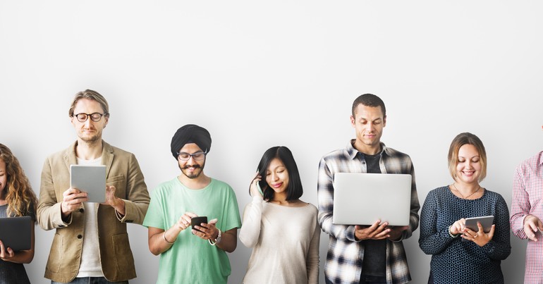 line of five people of different age, race, ethnicity and gender using technology